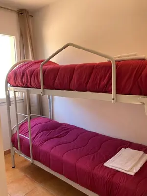 Un ou plusieurs lits dans un hébergement de l'établissement Punta di mare, appartements bord de mer