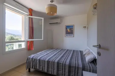 Un ou plusieurs lits dans un hébergement de l'établissement Maison Fab & Jo - Proche de lîle rousse