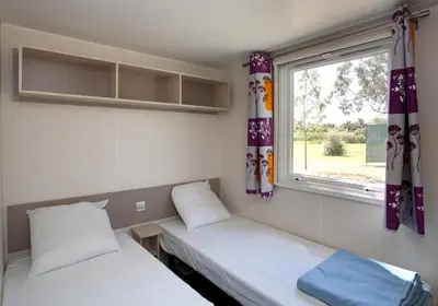Un ou plusieurs lits dans un hébergement de l'établissement Camping Miami plage