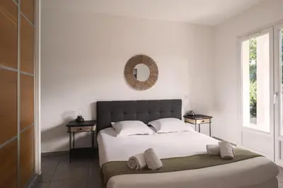 Un ou plusieurs lits dans un hébergement de l'établissement Villa de charme Jo Poggi - Domaine Romella - Piscine - Proche St-Florent