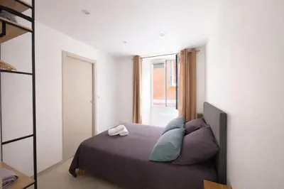 Un ou plusieurs lits dans un hébergement de l'établissement Appartement T3 Place du Marché