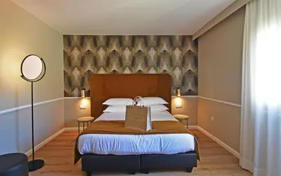 Un ou plusieurs lits dans un hébergement de l'établissement Hotel Restaurant Christophe Colomb