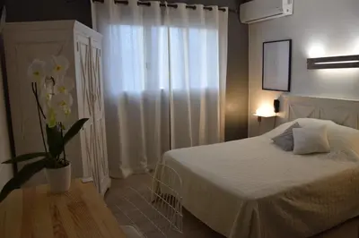 Un ou plusieurs lits dans un hébergement de l'établissement Hôtel le Grillon