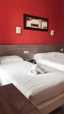 Un ou plusieurs lits dans un hébergement de l'établissement Hotel Riviera