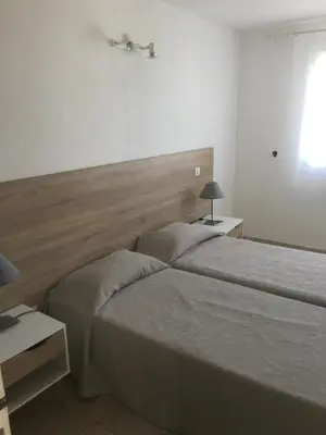 Un ou plusieurs lits dans un hébergement de l'établissement Appart'Hôtel A Punta