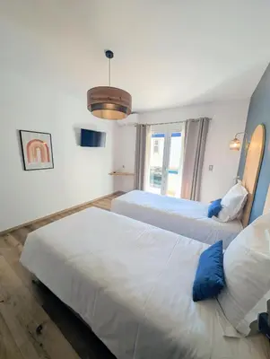 Un ou plusieurs lits dans un hébergement de l'établissement Hôtel Flor