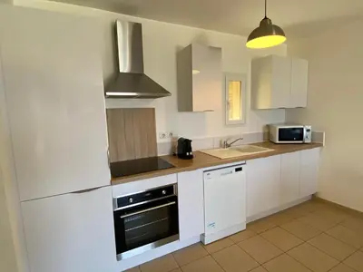 Cuisine ou kitchenette dans l'établissement La Citadelle Appartements