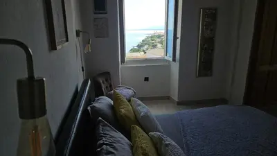 Un ou plusieurs lits dans un hébergement de l'établissement pietranera village terrasse vue exceptionnelle sur la mer