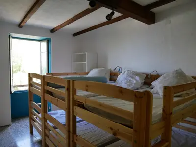 Un ou plusieurs lits dans un hébergement de l'établissement Cap Corse - Grande maison au bord de mer - PMR
